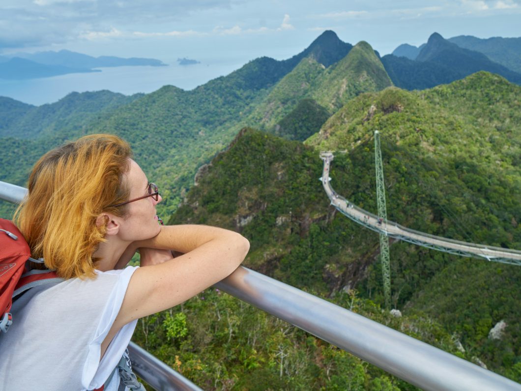 a young woman at a scenic overlook in Thailand