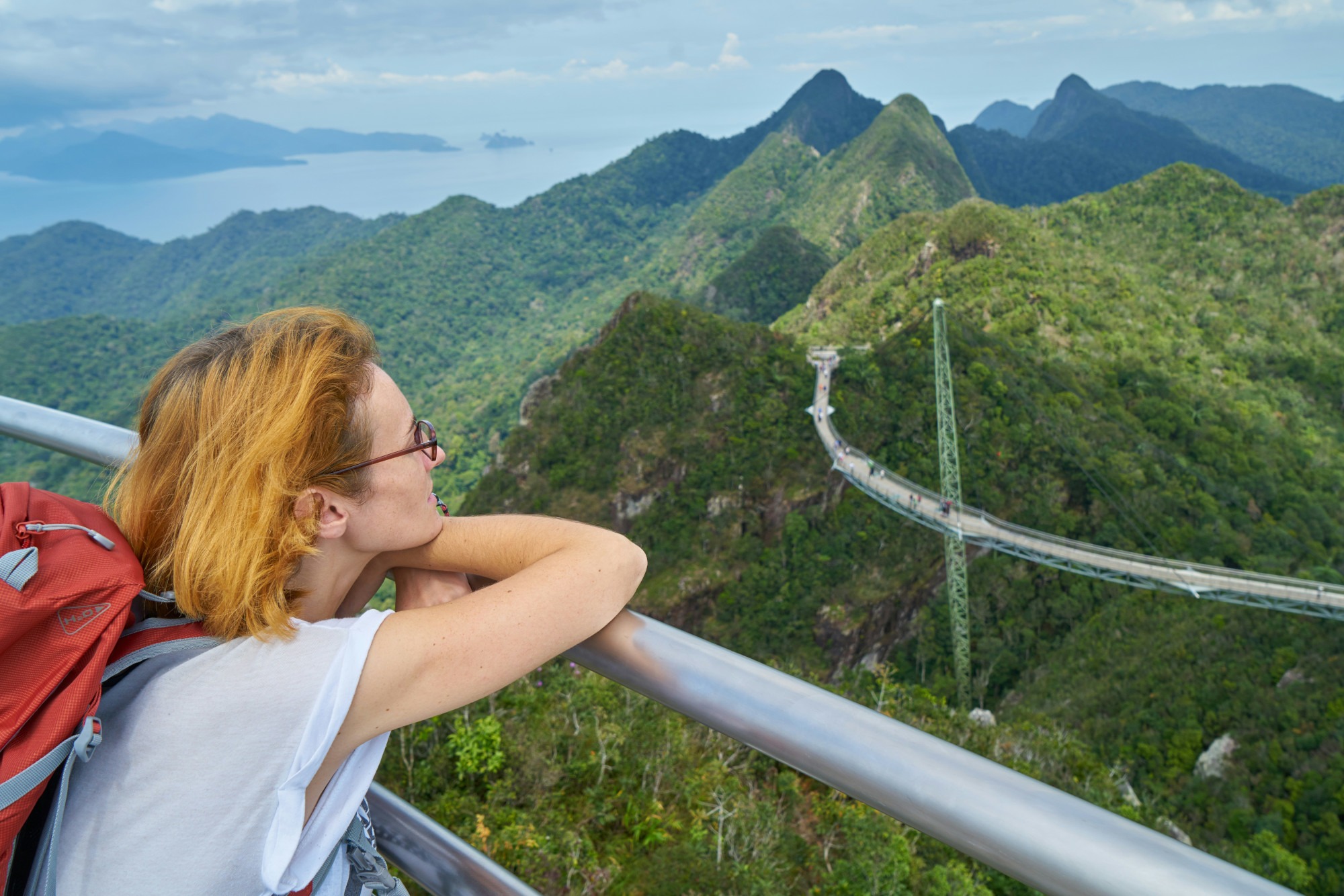 a young woman at a scenic overlook in Thailand